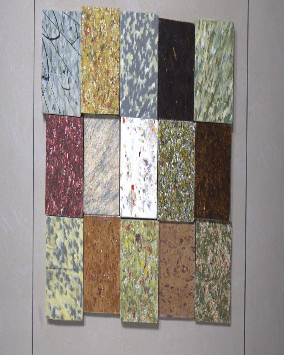 A grid of composite board samples in speckled greens, reds, creams and charcoal.